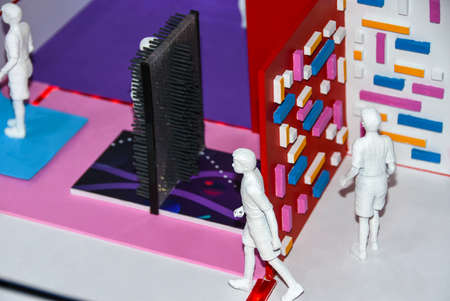 Figures of people in a miniature educational class on teaching information technology of the future....