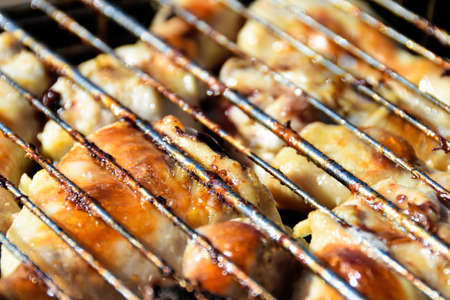 Roasted chicken legs on the grill with fire