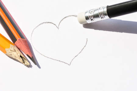 Washing on pencil erases the painted heart. Simple pencils symbolize ruined love