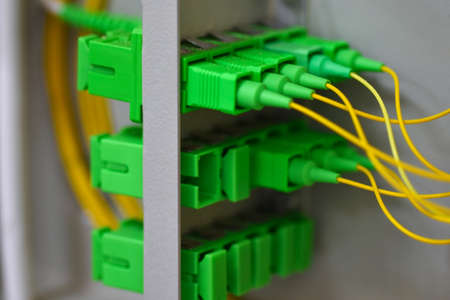 Many optical patch cords in telecommunications cabinet