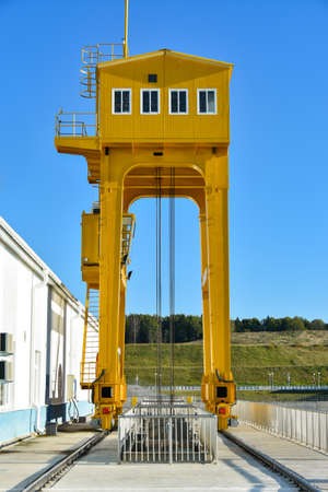 Yellow crane to raise gate of the hydroelectric station