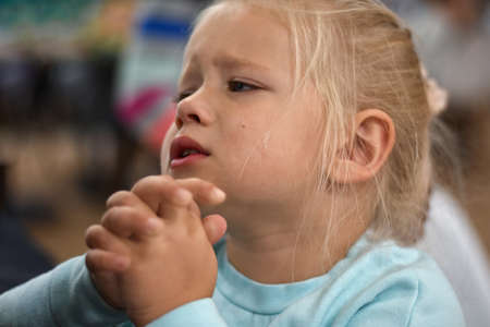 Little girl cries and asks to buy a toy from her mother, portrait, tearsの写真素材