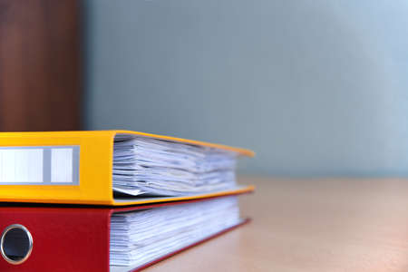 Large color folders for documents on the table in office, close-up, copy space