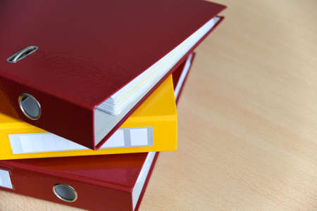 Large color folders for documents on the table in office, close-up, copy space