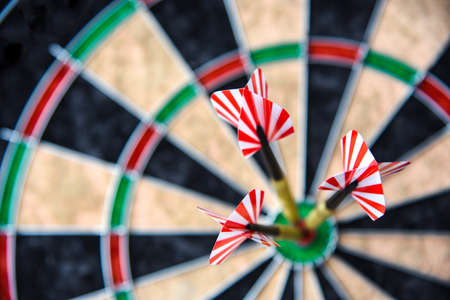 Three darts in the sports circle for playing darts, close up