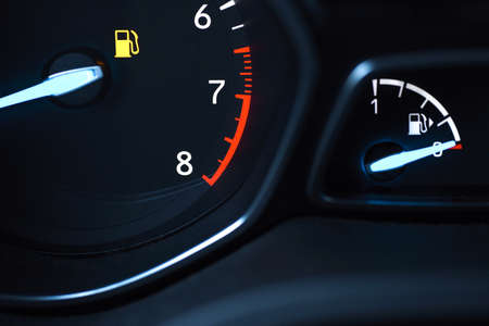 Display devices on the car panel show that fuel in the tank is running low