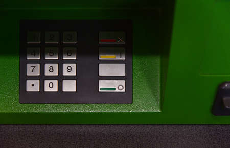 ATM keyboard, green, shade, close-up.