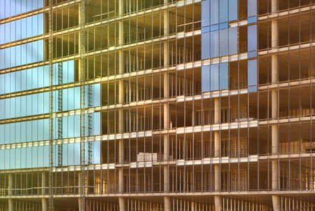 Glass wall of a monolithic building under construction.