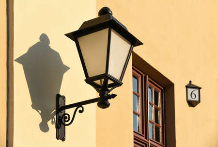 Retro lantern on the wall of an old house.の写真素材