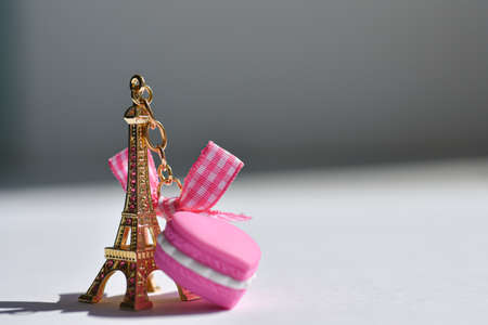 Souvenir golden eiffel tower with a purple heart on a white background.の写真素材