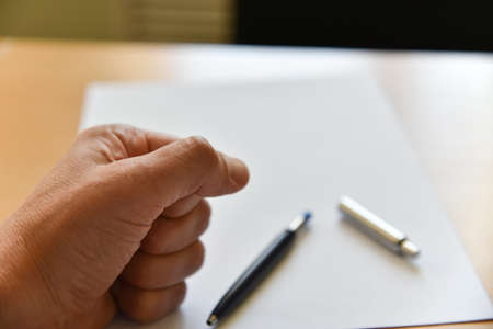 Stress at work. Fist on office table.の写真素材