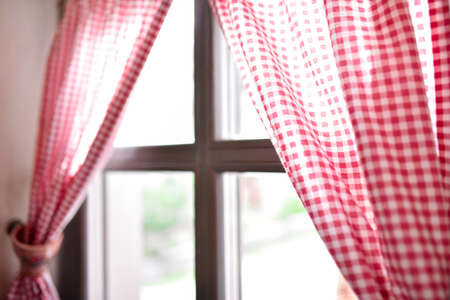 Wooden window with checkered curtains in the houseの写真素材