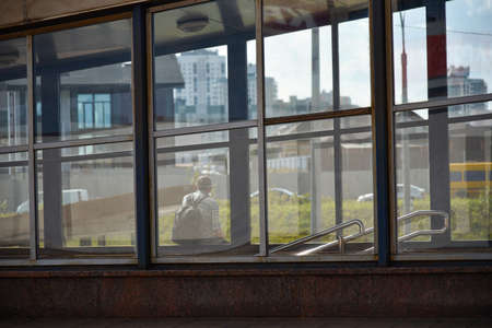 Lonely man at a bus stop waiting for public transport.