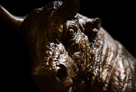 Iron head of a bull on a black background.の写真素材