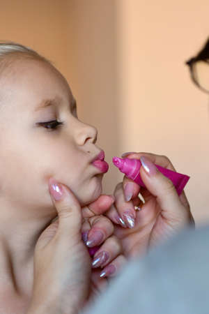 Makeup artist paints lipstick to a girl dancer.の写真素材