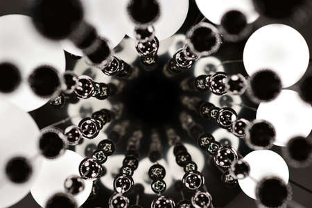 Large chandelier with round shades and metal balls.