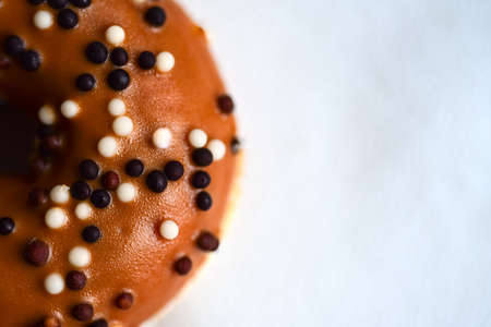 Isolated donut with chocolate balls, copy space.の写真素材