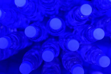 Bottles of clean drinking water on a blueの写真素材