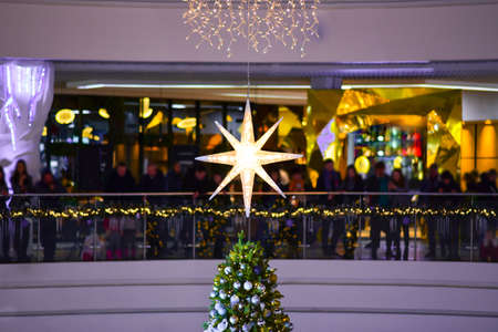Christmas star on a Christmas tree in a shopping center.の写真素材