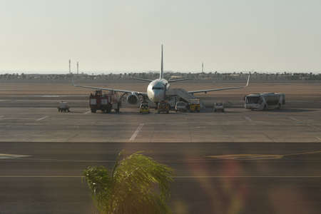 Pre-flight passenger airplane service at an African airport.