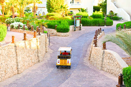 A driver rides in a passenger carriage through a hotel in Egypt.