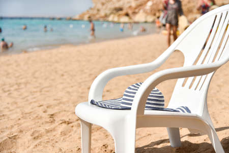 Hat on a chair on the beach.