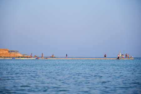 People swim and watch corals from a pier in the Red Sea.の写真素材