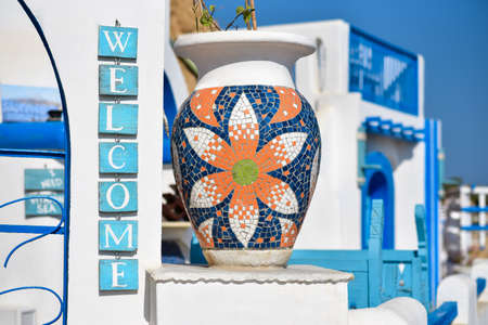 The inscription welcome to the sign of a Greek cafe.