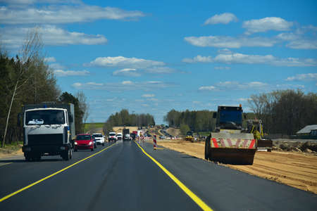 Cars circle the road under construction.の写真素材
