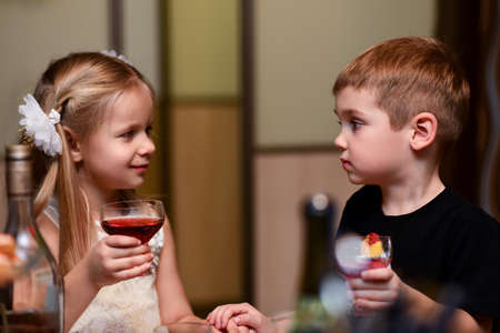 Children boy with girl drink together on holiday.の写真素材