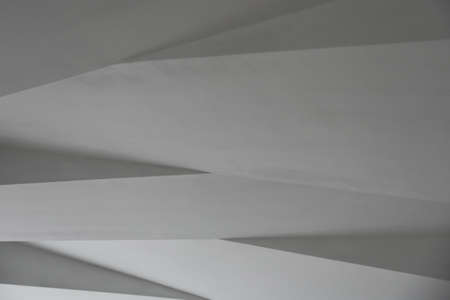 Ceiling with white triangular shapes.
