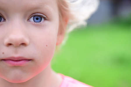 Portrait of a surprised blonde child girl with her hair.の写真素材