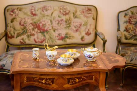 Serving dining table in a golden royal interior.のeditorial素材