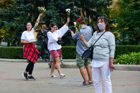 Editorial photo People with white bracelets and flowers at a protest against Lukashenka government...