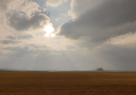 Sun rays through clouds, autumn field, fog, evening.