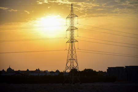 High voltage power line at sunset in an arab country.の写真素材