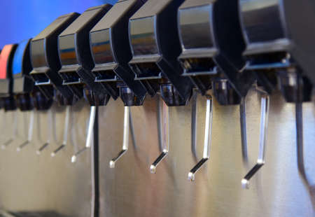 Automatic filling machine for carbonated drinks into cups.