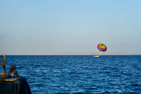 Attraction parachute flight from a yacht over the sea.