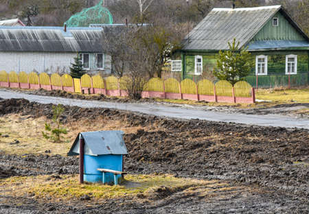 Old well in the field near the road in the village.の写真素材