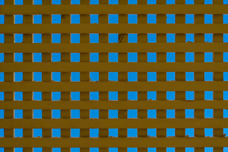 Old wooden lattice against the blue sky.の写真素材