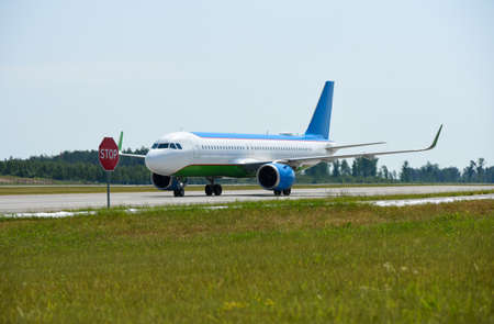 A passenger plane traveling on the runway at the airport, flight ban, stop sign, Belarus, Minsk.