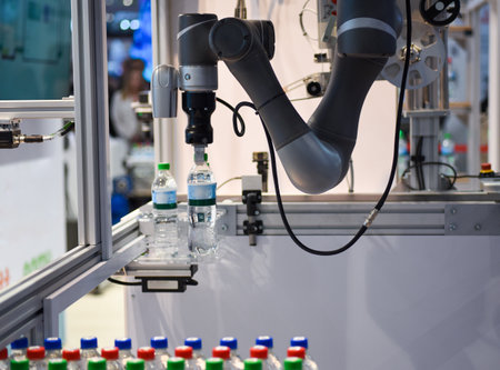 Robotic arm serving water bottles.の写真素材