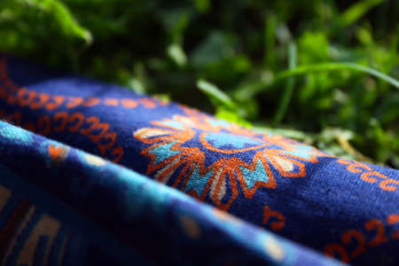 Fabric with a colorful pattern on the grassの写真素材