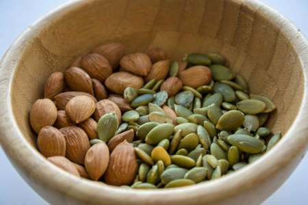 Mix with almonds, and pumpkin seeds in a wooden bowlの写真素材