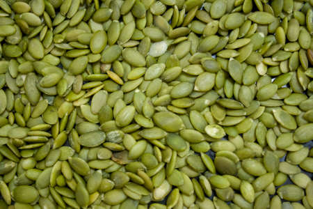 Macro background texture of green pumpkin seedsの写真素材