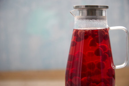A glass carafe stands on the kitchen table, filled with a delicious vitamin compote brewed from...