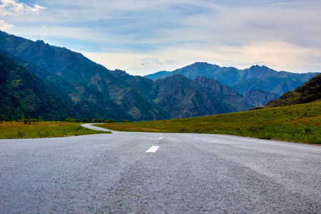 Paved winding highway in the picturesque mountains. Winding empty mountain road. Desert trail leading to the top of the mountainの写真素材