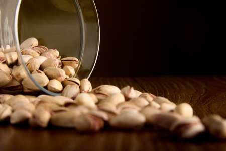 Dried, fried, salty, appetizing pistachios spilled out of the dishes on the table. Salty delicious...