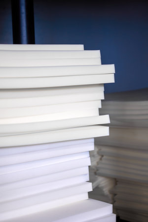 Soft foam sheets are stacked on top of each other in a warehouse for the production of furniture....
