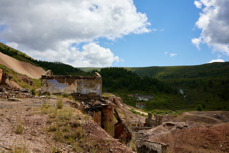 A haunting scene of a bombed-out house stands in desolation against a rugged mountainous backdrop....